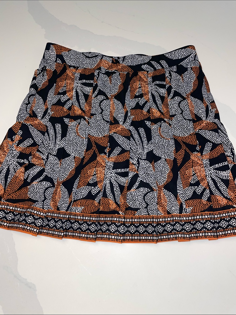 Chico’s pleated skirt, brownish, orange and black patterned.